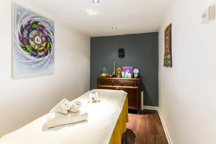 Treatment room with a mandala painting and a dark green wall